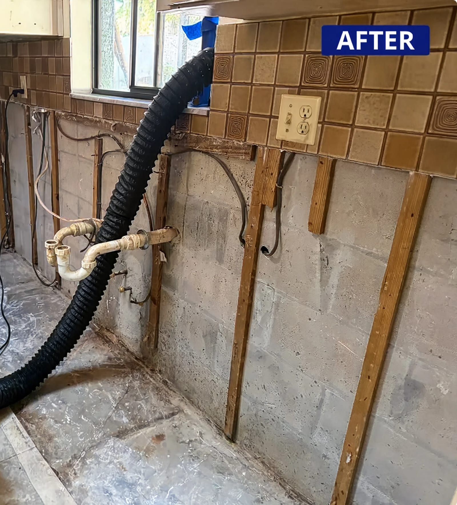 After: the same wall stripped back and drying